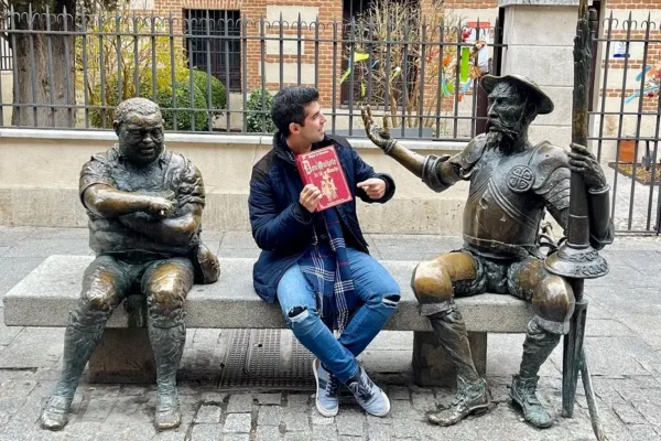 Accounting-Intern-with-book-on-bench-with-statues Accounting Intern with book on bench with statues