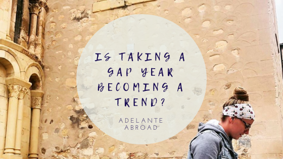 Person walking by stone wall with blog title about gap years.