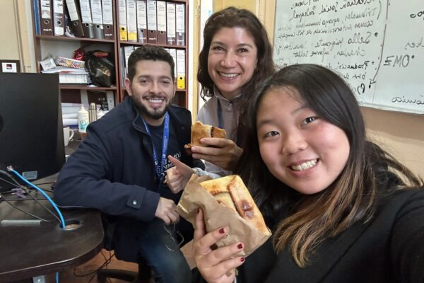 Internship-in-Chile-5-scaled Group of interns sharing food in an office in Chile.