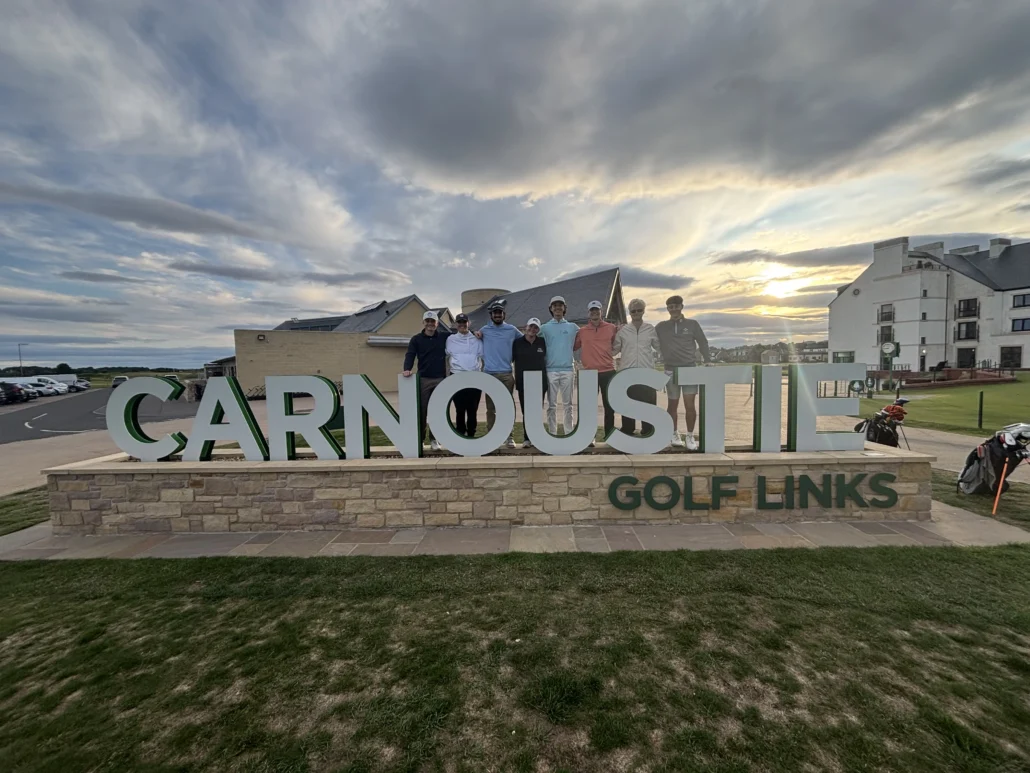 Interns abroad standing by Carnoustie Golf Links sign