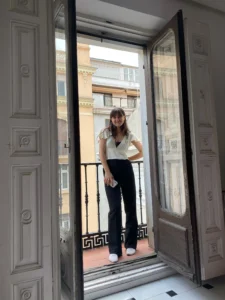Student standing on balcony in Madrid