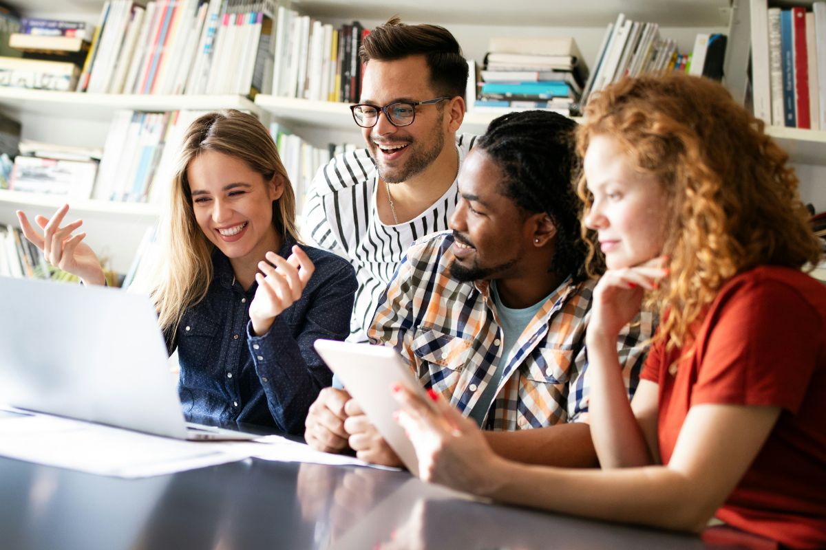 Group of students collaborating with laptop