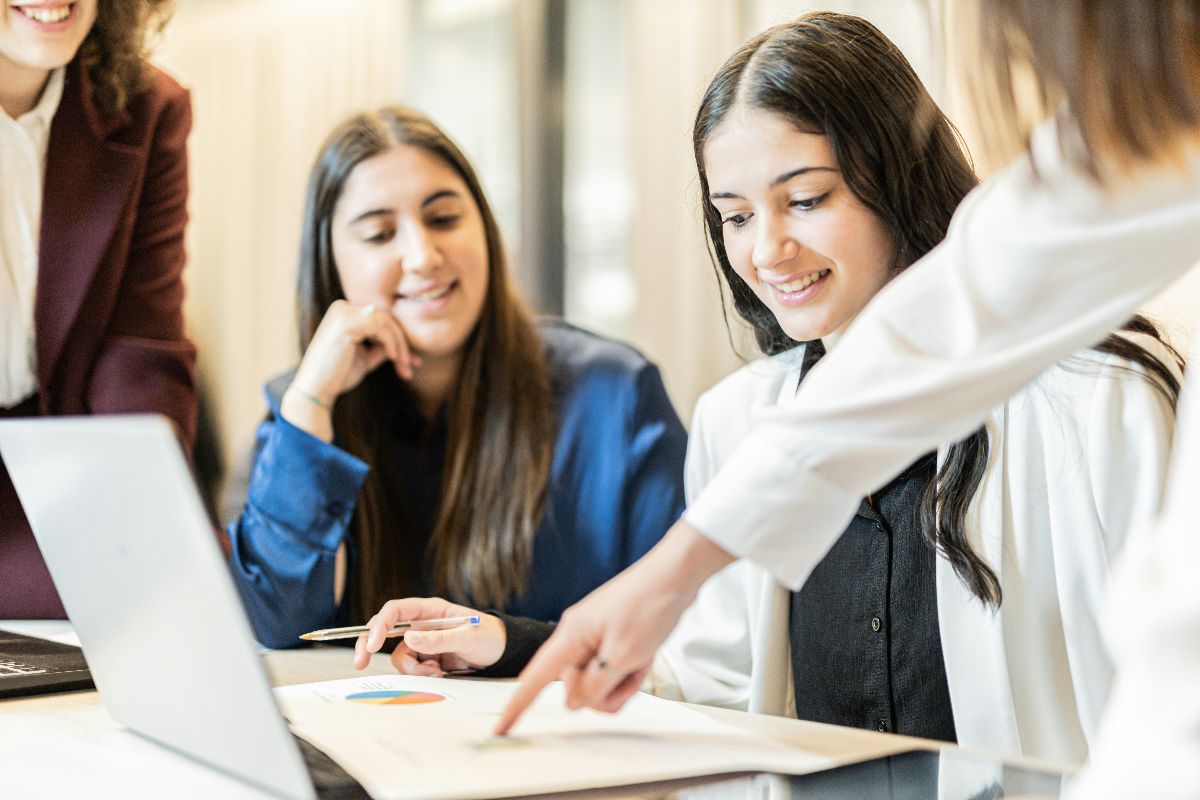 Female professionals reviewing charts and data together at a desk