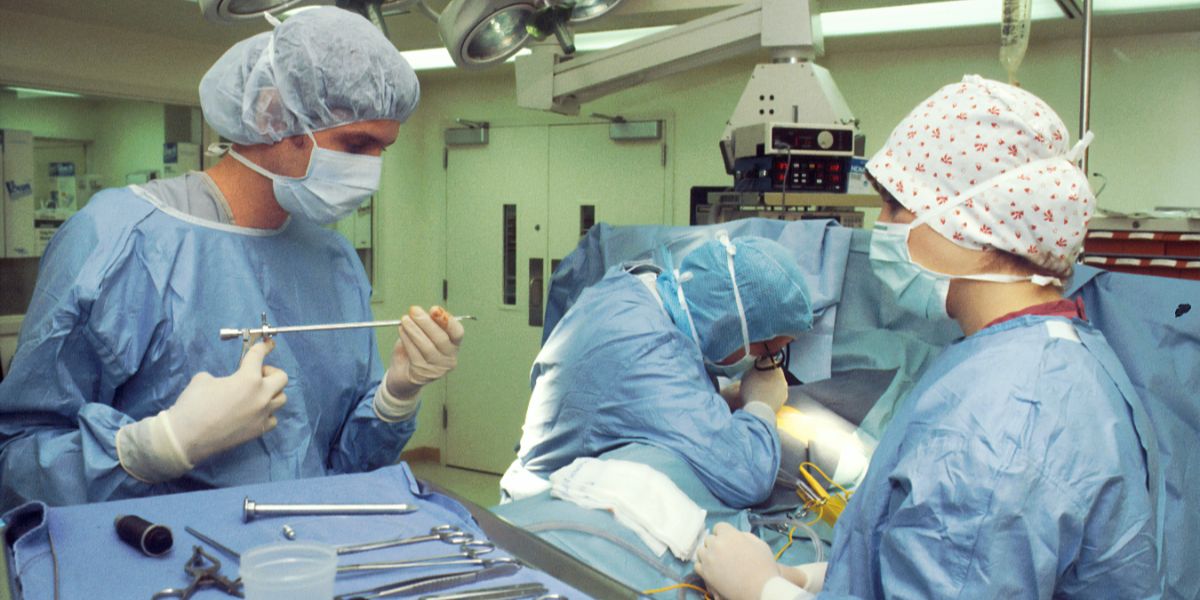Medical professionals performing a surgical procedure.