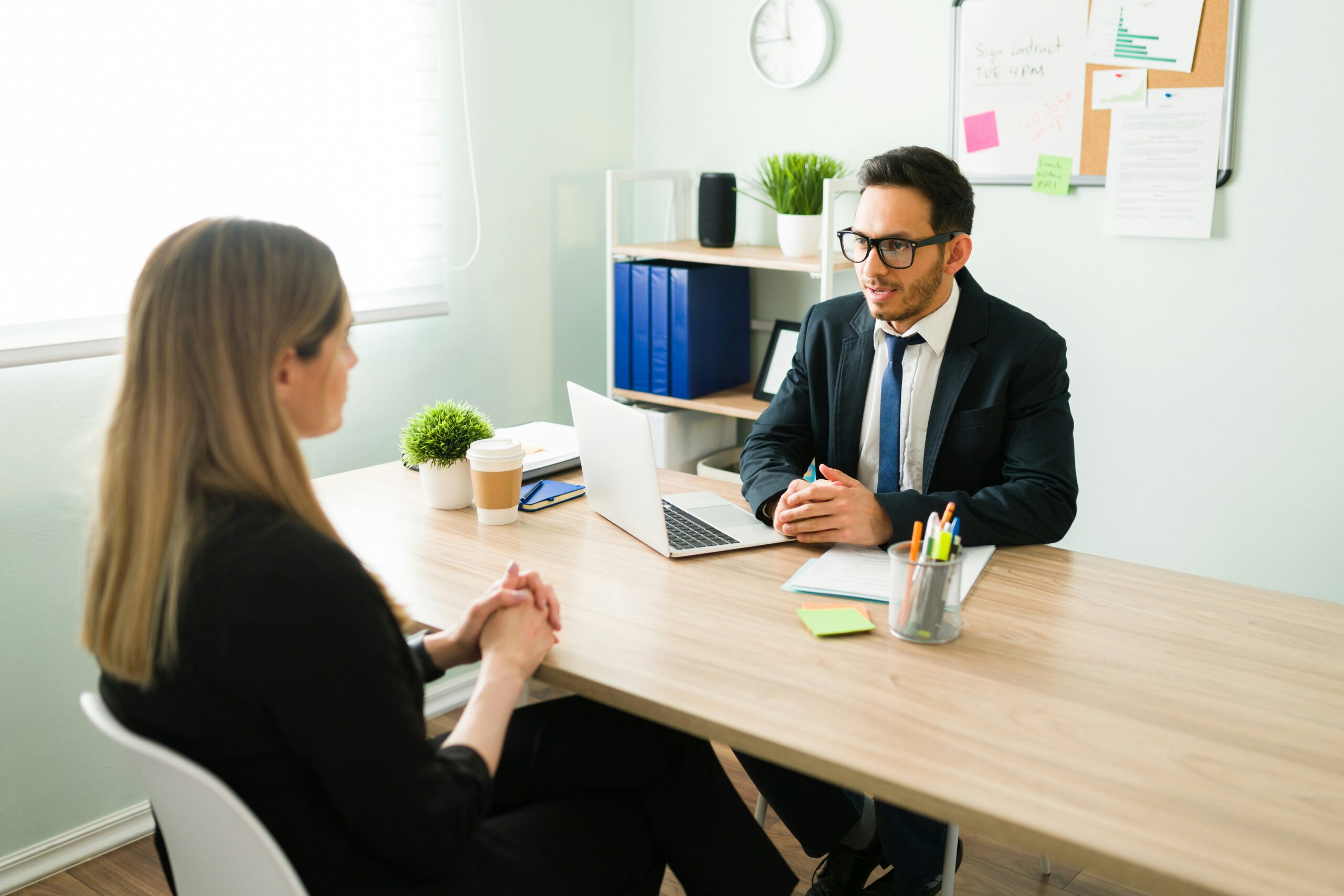 Woman preparing for a job interview with an interviewer sitting across a table